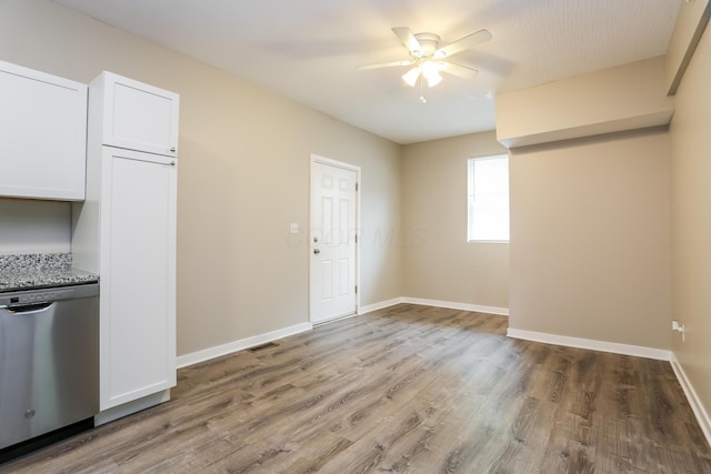 interior space with stone counters, ceiling fan, stainless steel dishwasher, white cabinets, and hardwood / wood-style flooring