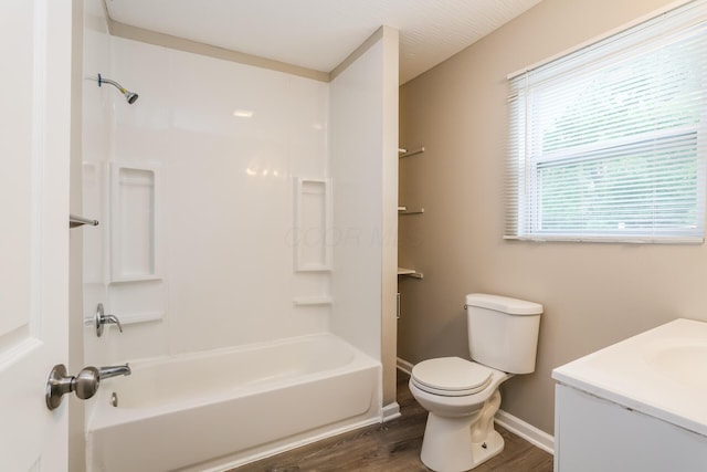 full bathroom featuring bathtub / shower combination, vanity, hardwood / wood-style flooring, and toilet