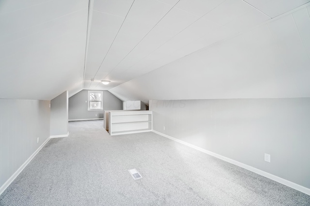 additional living space with light carpet and lofted ceiling