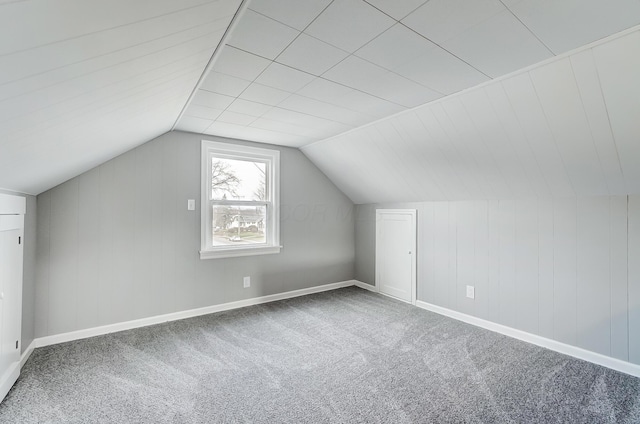 bonus room with carpet and vaulted ceiling