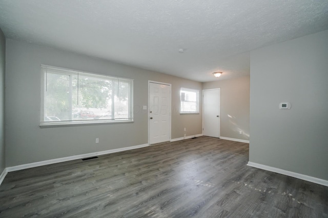 foyer with a textured ceiling and dark wood-type flooring