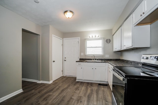 kitchen featuring electric range, white cabinets, sink, and dark wood-type flooring