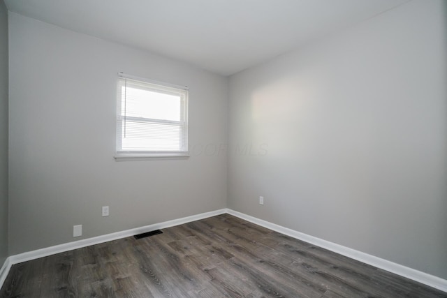 spare room featuring dark hardwood / wood-style flooring