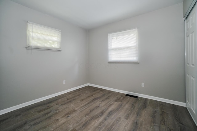 spare room featuring dark hardwood / wood-style flooring