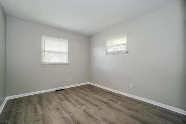 spare room with dark hardwood / wood-style flooring