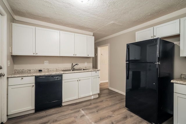 kitchen featuring white cabinetry, sink, black appliances, and light hardwood / wood-style floors