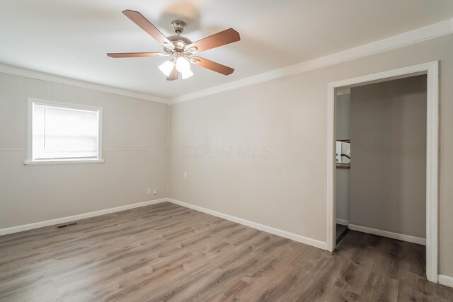 unfurnished bedroom featuring hardwood / wood-style floors, ceiling fan, and ornamental molding