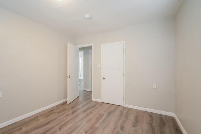 unfurnished bedroom with light wood-type flooring