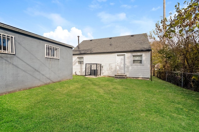 rear view of house featuring a lawn