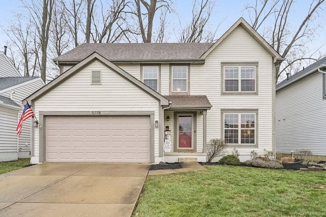 view of front of property featuring a garage and a front lawn