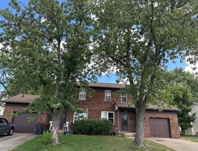 view of front of home with a front yard and a garage