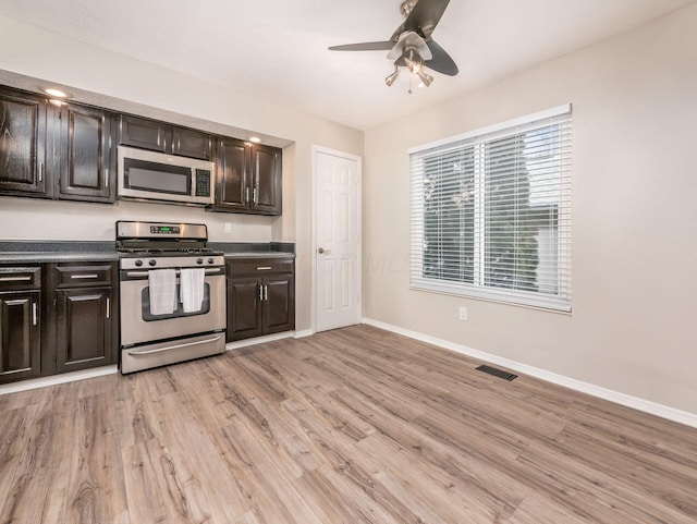 kitchen featuring light wood-style flooring, visible vents, baseboards, and stainless steel appliances