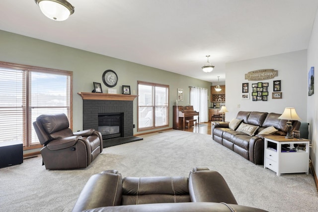 living room with carpet floors and a brick fireplace