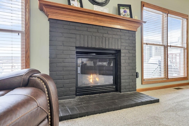 details featuring carpet floors and a brick fireplace