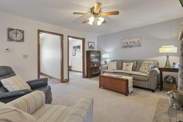 living room with ceiling fan and light colored carpet