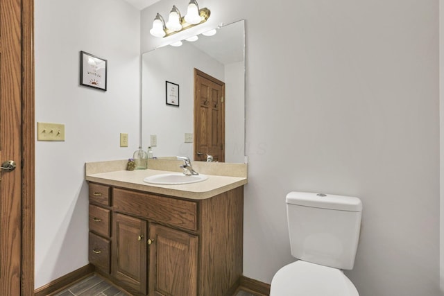 bathroom with hardwood / wood-style flooring, vanity, and toilet