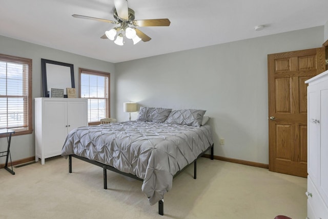 bedroom featuring light colored carpet and ceiling fan