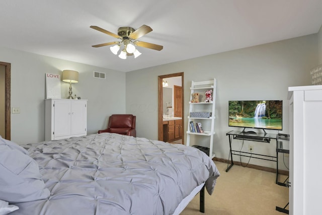 bedroom featuring ceiling fan, ensuite bathroom, and light carpet