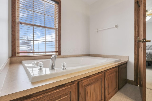 bathroom with a bath and tile patterned floors