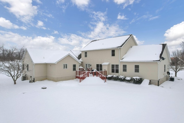 snow covered back of property with central air condition unit