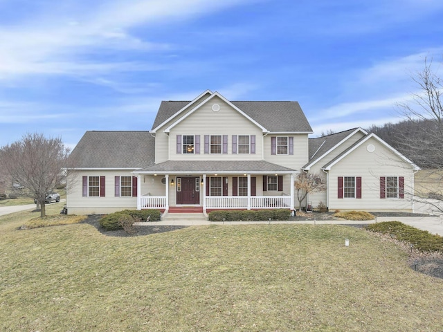 view of front of house with covered porch and a front lawn