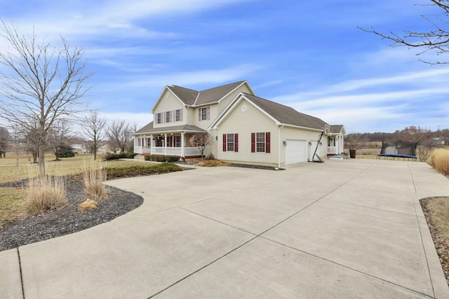 view of front of house with a trampoline, a garage, and a porch