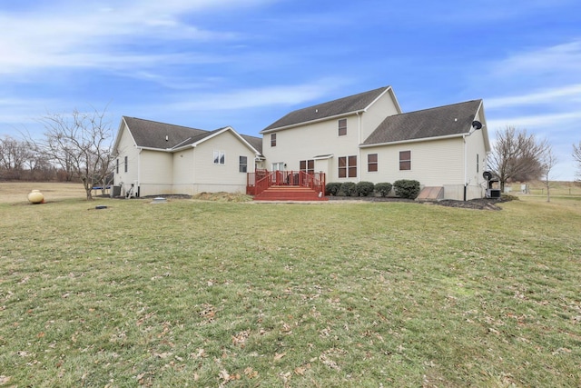 back of house featuring a wooden deck, central air condition unit, and a lawn