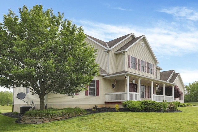 3628 State Route 361, Circleville, OH 43113 - view of front of property featuring covered porch, a front lawn, a shingled roof, and central AC