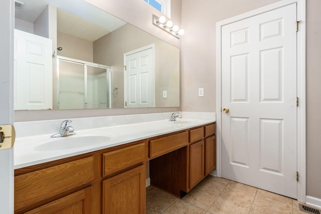 bathroom with tile patterned flooring, vanity, and walk in shower