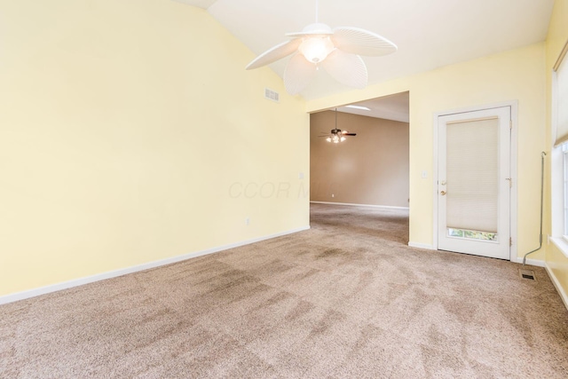 spare room featuring carpet flooring, ceiling fan, and vaulted ceiling