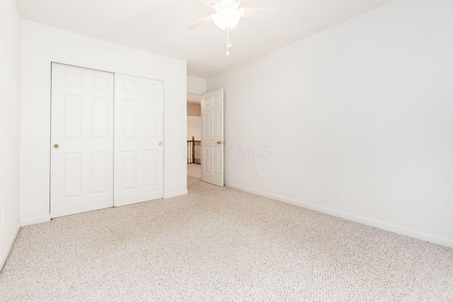 unfurnished bedroom with carpet floors, a closet, and ceiling fan