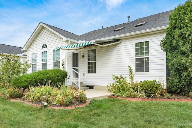 back of house featuring a patio area and a yard