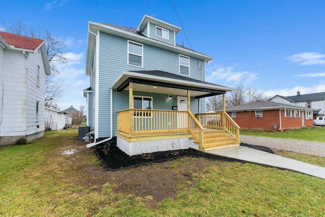 view of front facade with covered porch and a front lawn