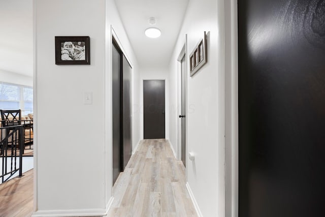 hall with light hardwood / wood-style flooring