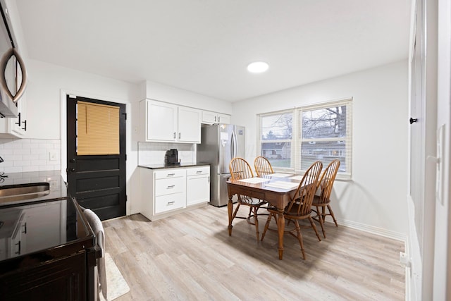 dining room featuring light hardwood / wood-style floors and sink