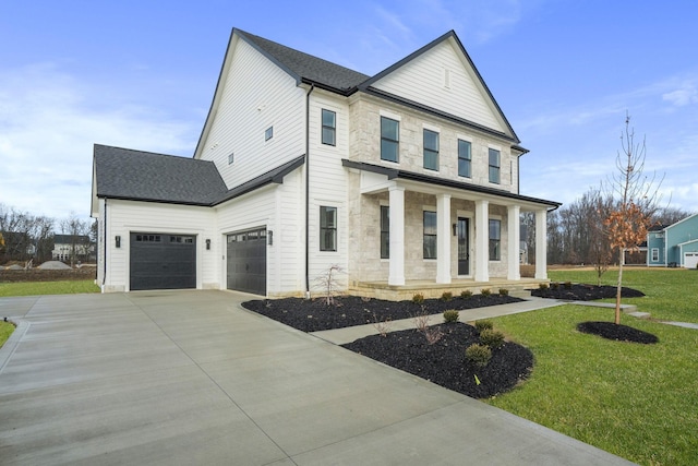 view of front of property featuring covered porch, driveway, a shingled roof, and a front yard