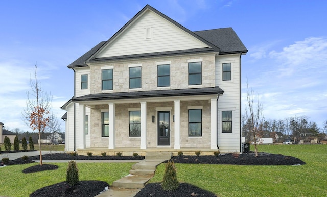 view of front of house featuring a porch, stone siding, and a front lawn