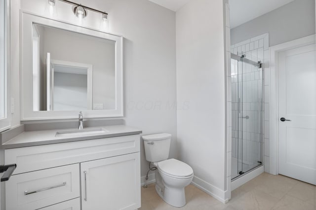 full bathroom featuring toilet, a shower stall, vanity, and baseboards