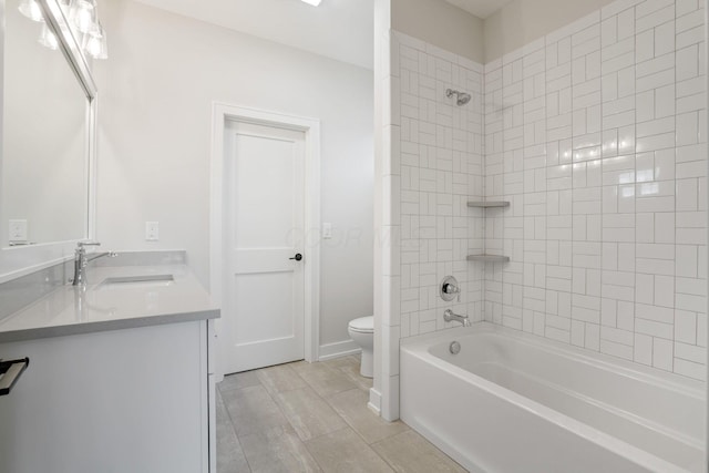 bathroom with double vanity, baseboards, toilet, shower / washtub combination, and a sink