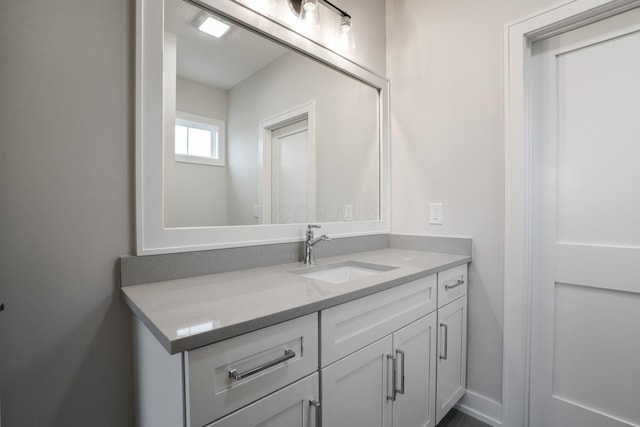 bathroom with vanity and baseboards