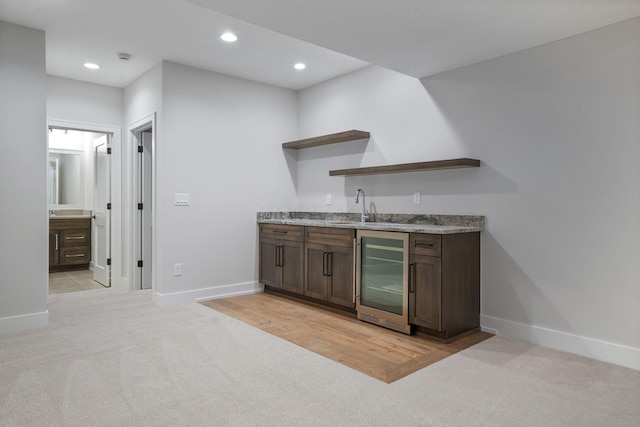 bar with light colored carpet, wine cooler, wet bar, a sink, and recessed lighting