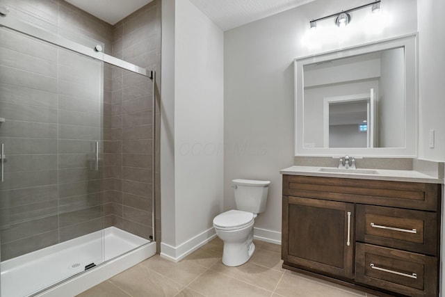 full bathroom with a stall shower, baseboards, toilet, and tile patterned floors