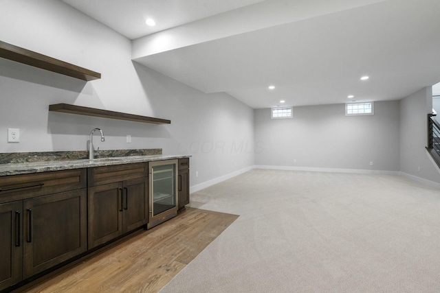 bar featuring wine cooler, recessed lighting, a sink, and baseboards