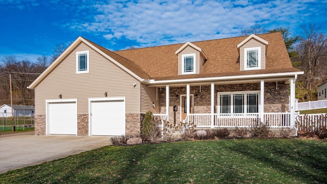 cape cod home with a porch, a garage, and a front lawn