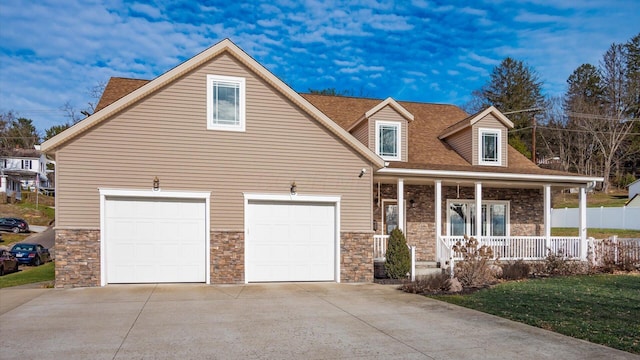 cape cod house featuring a porch and a garage