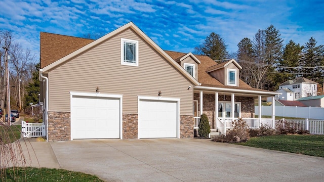 new england style home with a porch and a garage