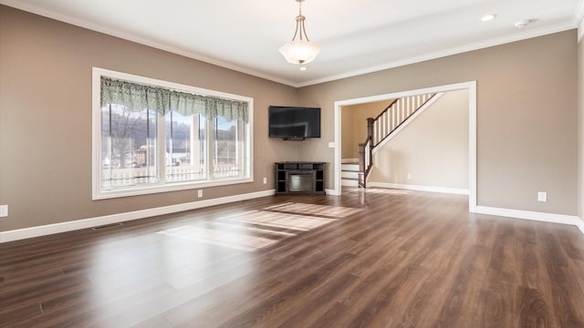 unfurnished living room with a fireplace, crown molding, and dark wood-type flooring