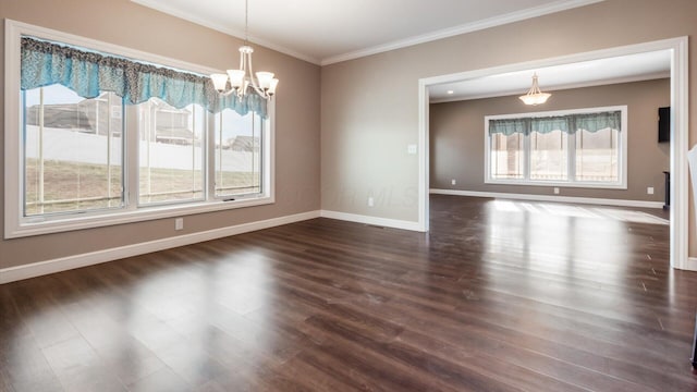 unfurnished dining area with plenty of natural light, a chandelier, dark hardwood / wood-style floors, and ornamental molding