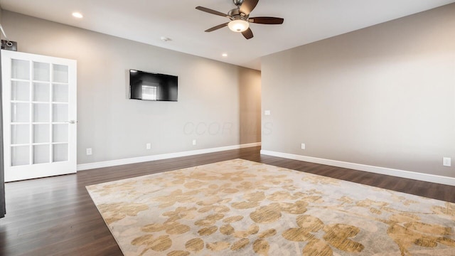 spare room featuring ceiling fan and dark wood-type flooring