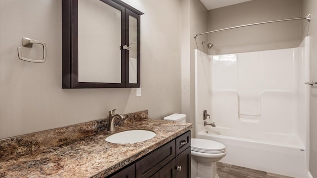 full bathroom featuring shower / bathing tub combination, vanity, and toilet